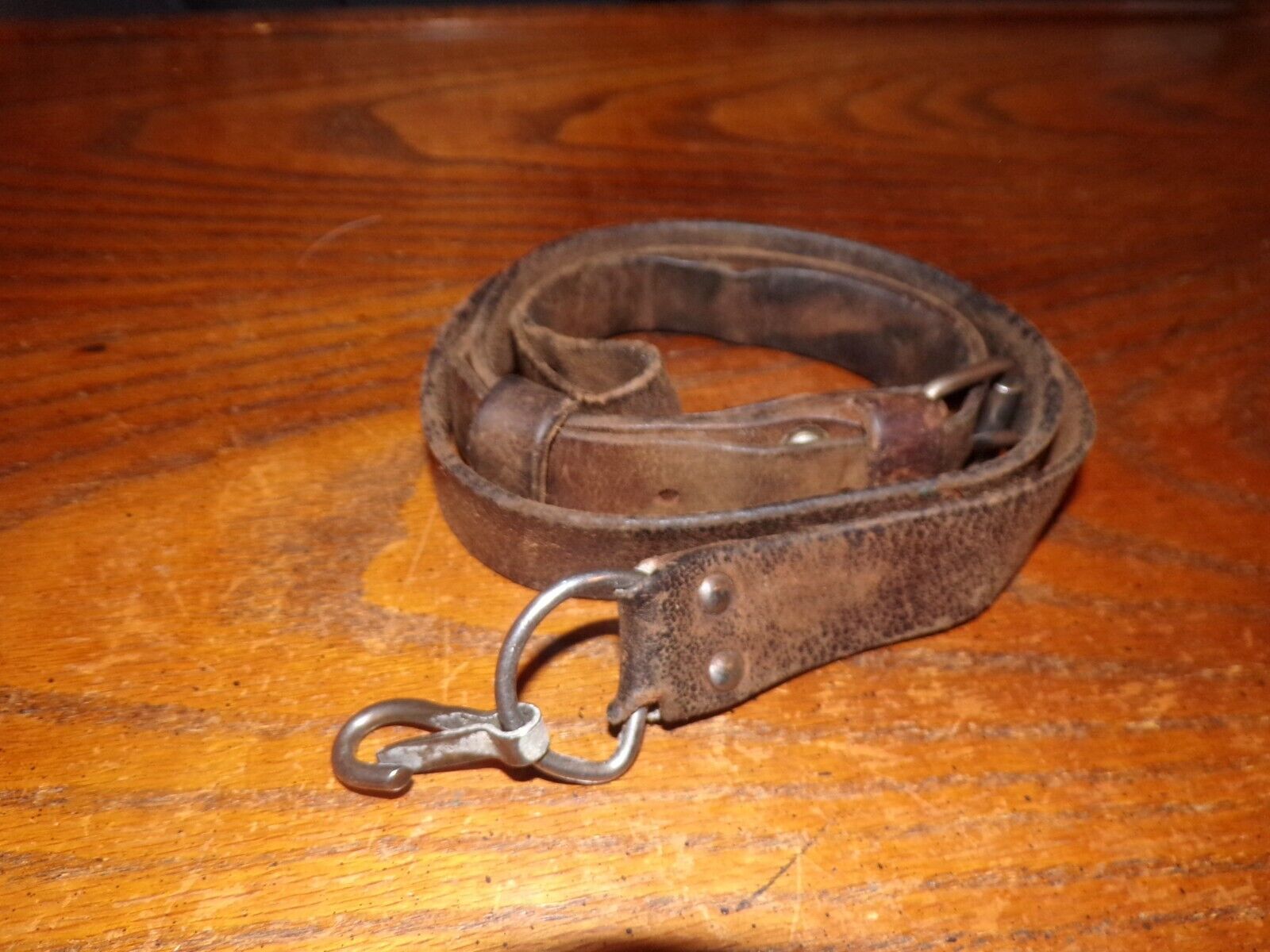Hungarian military very used brown leather rifle sling with clip on end dirty