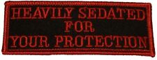 HEAVILY SEDATED FOR YOUR PROTECTION PATCH Red letters & trim on black background picture