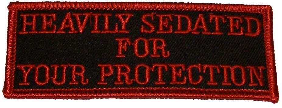 HEAVILY SEDATED FOR YOUR PROTECTION PATCH Red letters & trim on black background