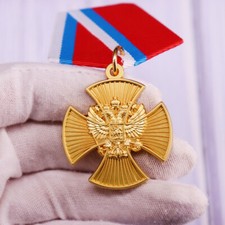 Medal Of Merit Cross Badge with an overlaid eagle of the Russian Federation