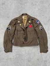WWII Military Jacket with Several Patches and Pins picture